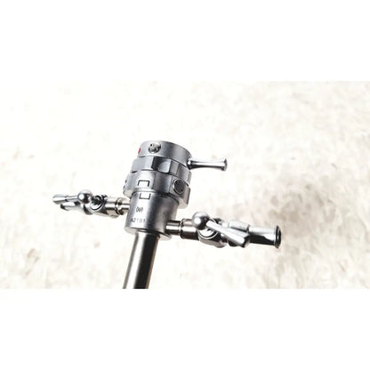Silver metallic olympus a2181 endoscope sheath with 27fr featuring a central shaft and three precision-tipped articulated arms