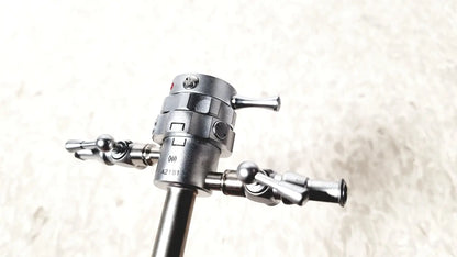 Silver metallic olympus a2181 endoscope sheath with 27fr featuring a central shaft and three precision-tipped articulated arms