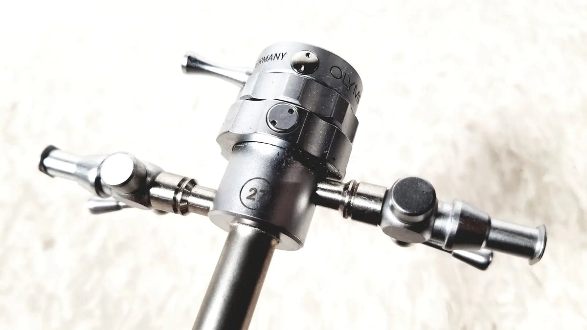 Silver metallic olympus a2181 endoscope sheath with engraved germany branding and three articulated arms design