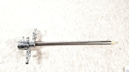 Silver surgical olympus a2181 endoscope with long slender metallic shaft and articulated control knobs at the handle