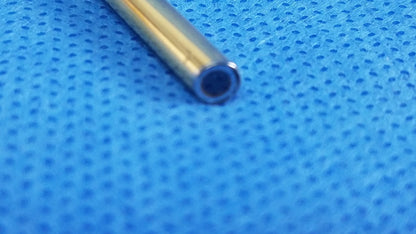 A sleek gold metal tube with polished finish and hollow interior for compatible olympus cystoscopic use a22002a