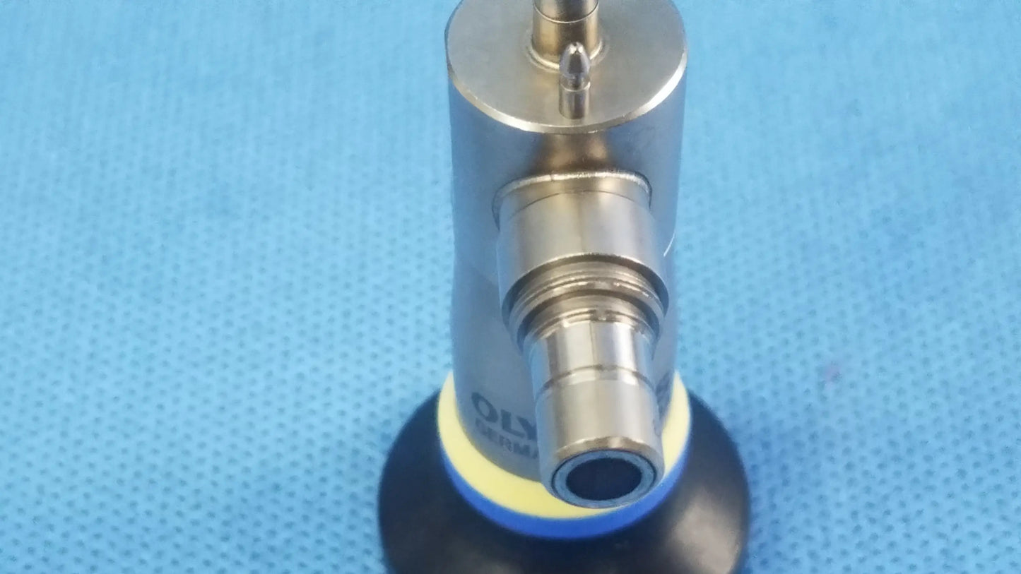 Silver-colored rigid scope with black rubber base and yellow accent ring compatible with Olympus endoscopic systems