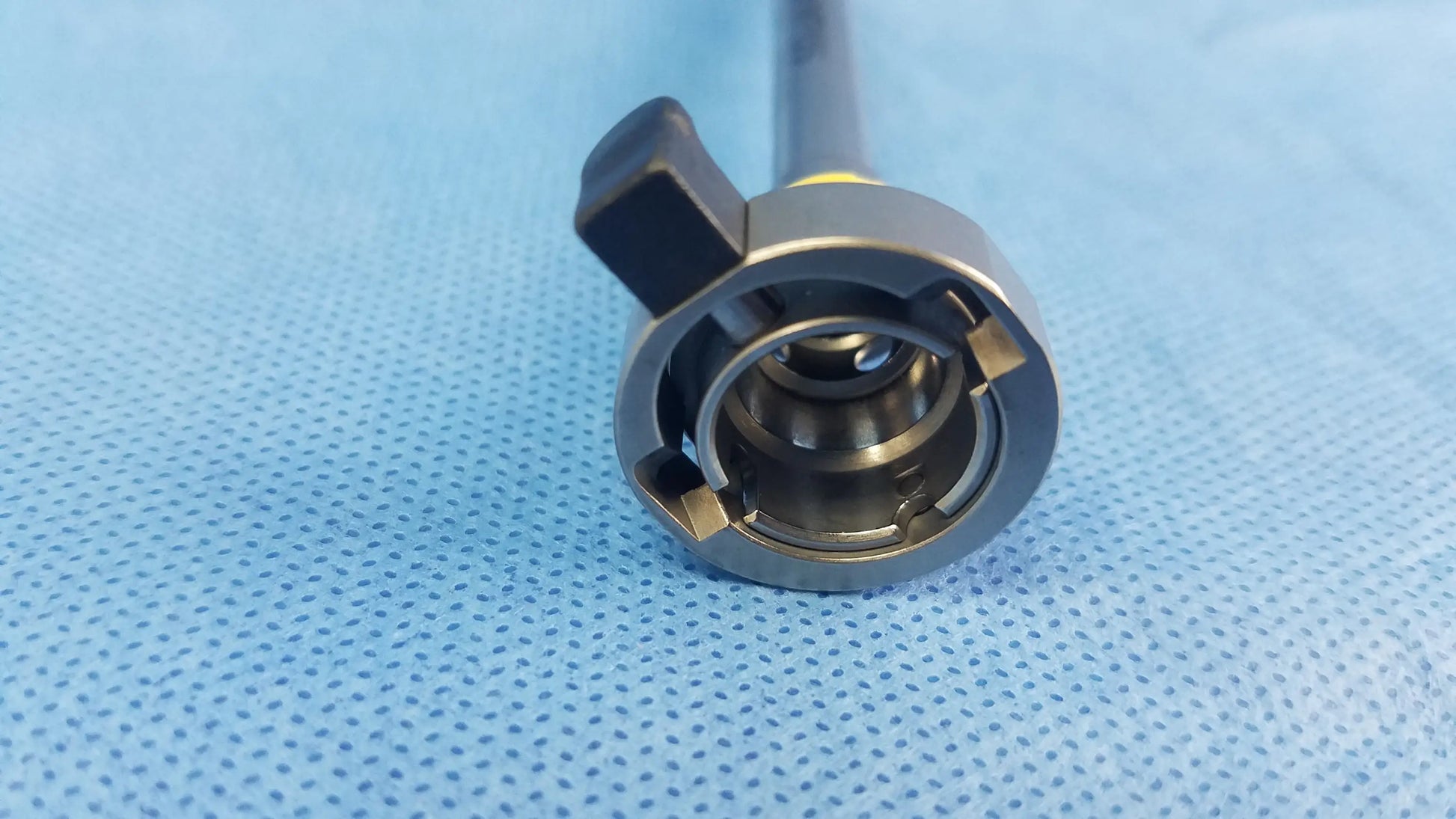 Silver hysteroscopic resectoscope inner sheath with black ergonomic handle and metallic joint instrument component