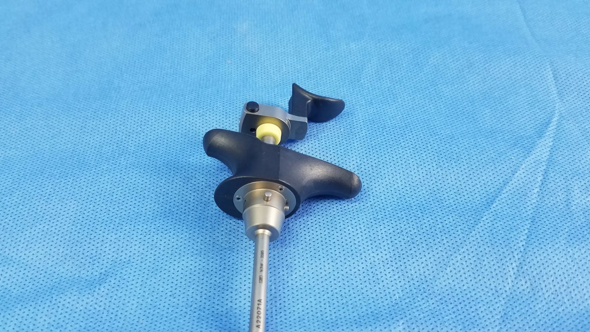 Black ergonomic handle with silver metallic shaft and yellow part of Olympus A22071A visual optical obturator