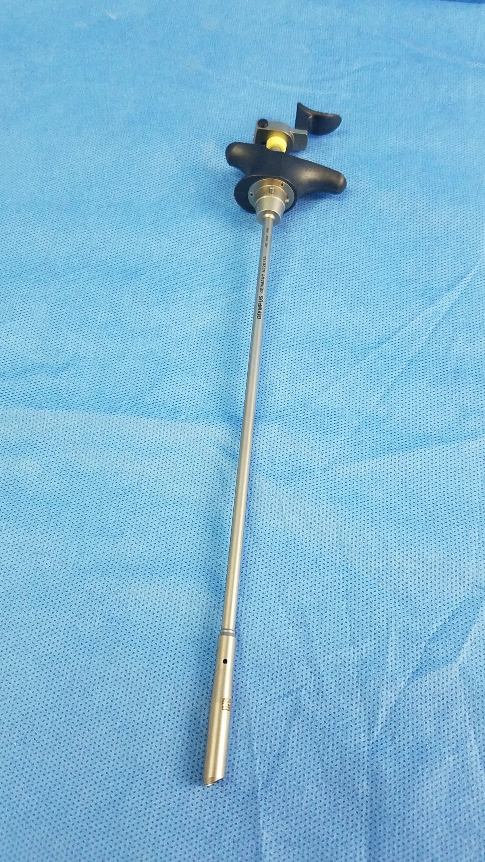 Silver surgical visual optical obturator with black ergonomic handle and yellow accent for precise optical obturator use
