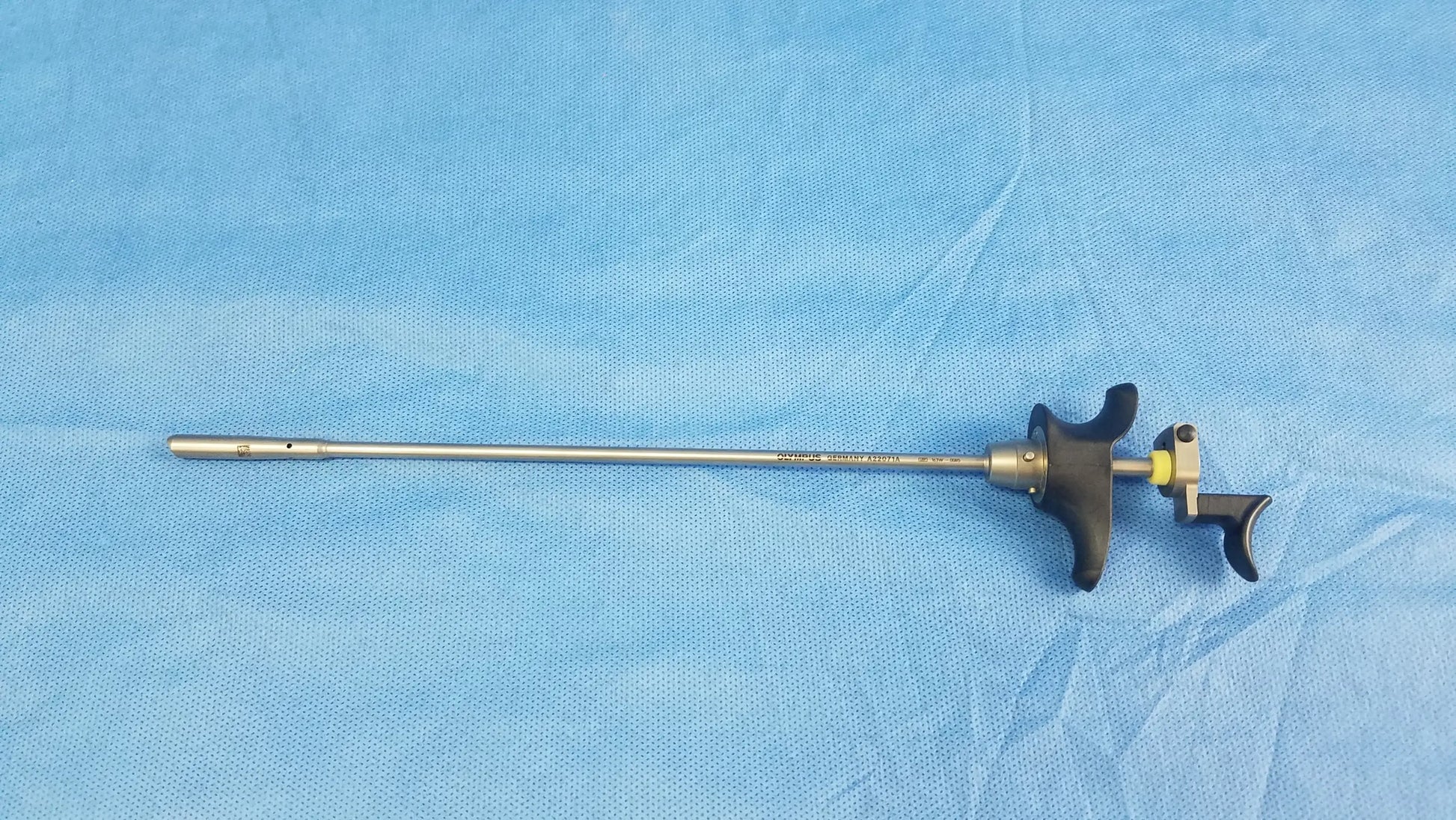 Olympus a22071a silver visual optical obturator with black ergonomic handles and yellow accent for precise surgical use