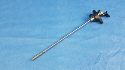 Silver surgical visual optical obturator with black ergonomic handle and yellow accents for precise optical use