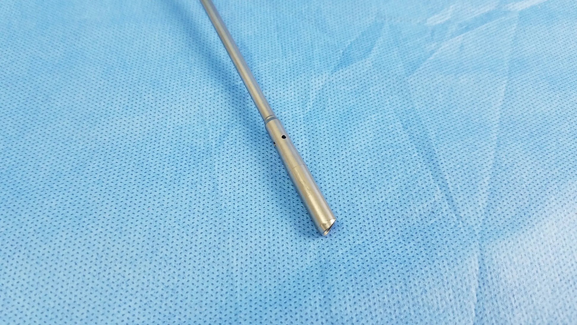 A sleek metallic visual optical obturator with a smooth cylindrical body and tapered end by olympus model a22071a