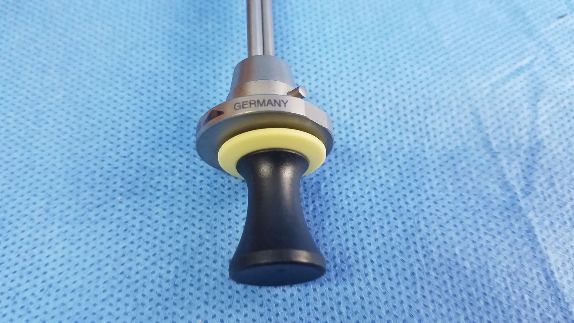 Silver deflecting obturator with black handle and yellow rubber ring marked germany compatible olympus instrument component