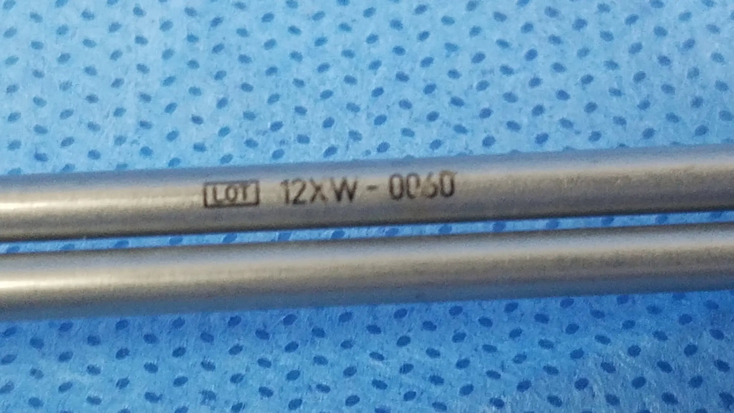 Two parallel metallic rods marked lot 12xw-0c50 on a blue surface as instrument components for compatible Olympus deflecting obturator