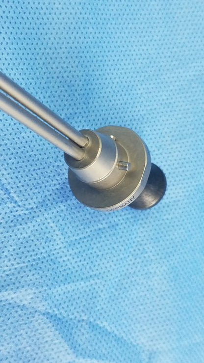 Silver-colored deflecting obturator surgical instrument with two slender rods and machined base compatible olympus A22086A