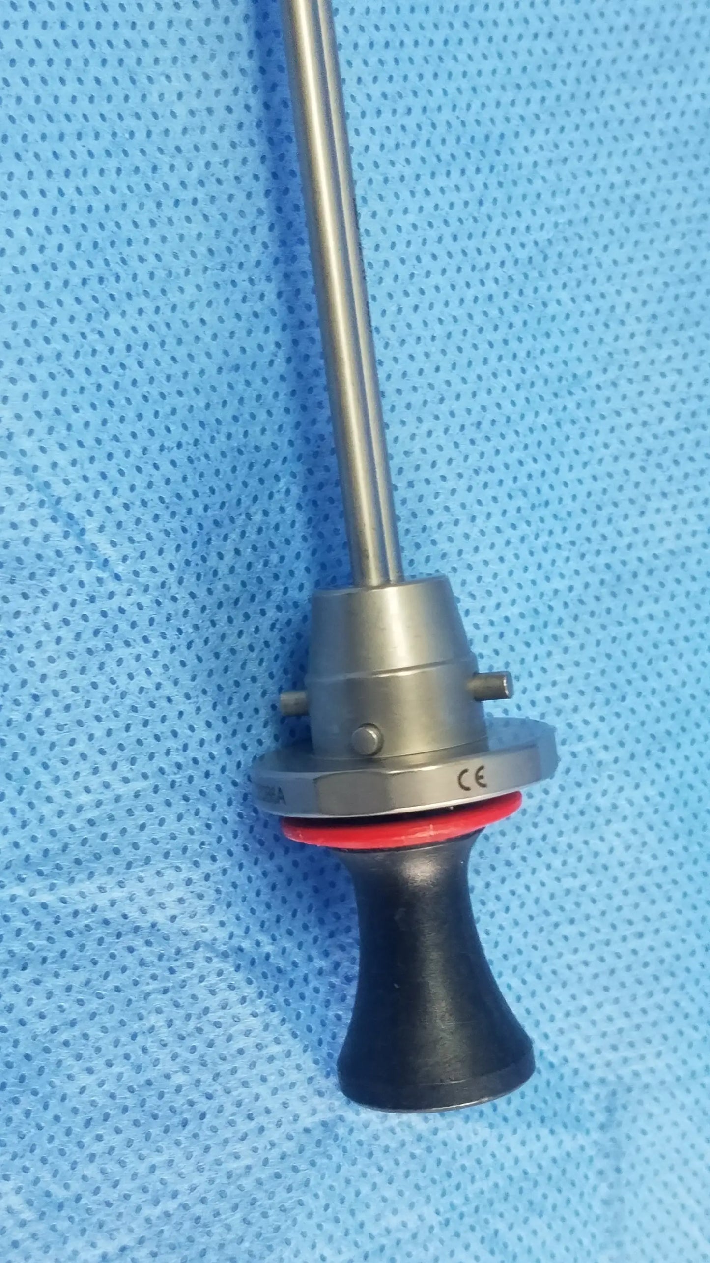 Silver surgical deflecting obturator instrument with black ergonomic handle and red seal compatible olympus A22086A
