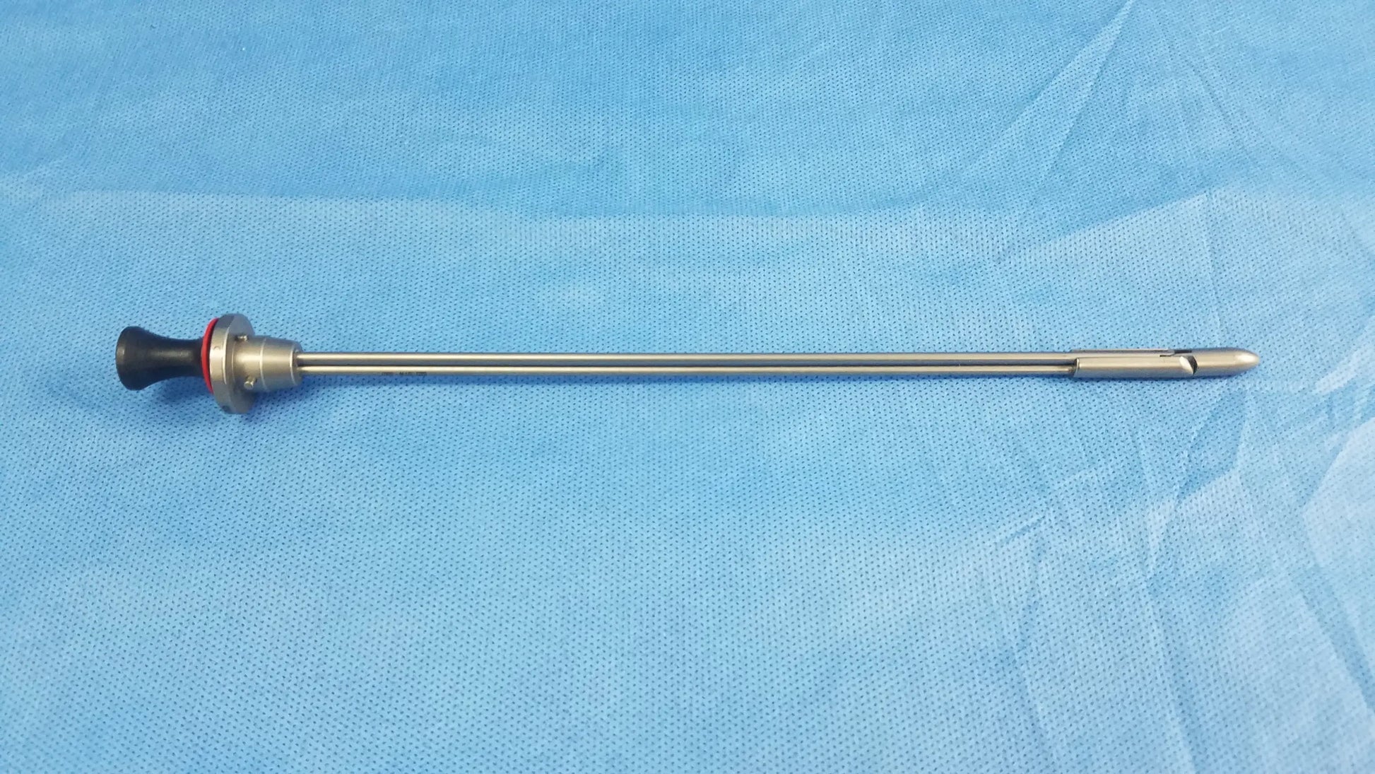 Olympus a22086a deflecting obturator surgical instrument with silver metallic shaft and black handle with red accent ring