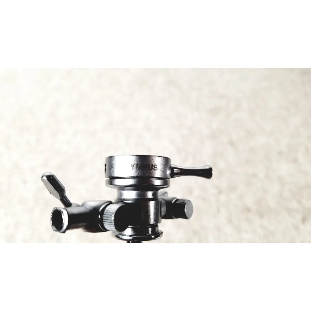 Black metal tripod head with silver ymrus logo and adjustable knobs for olympus a2211 dual valve sheath 17 fr instrument