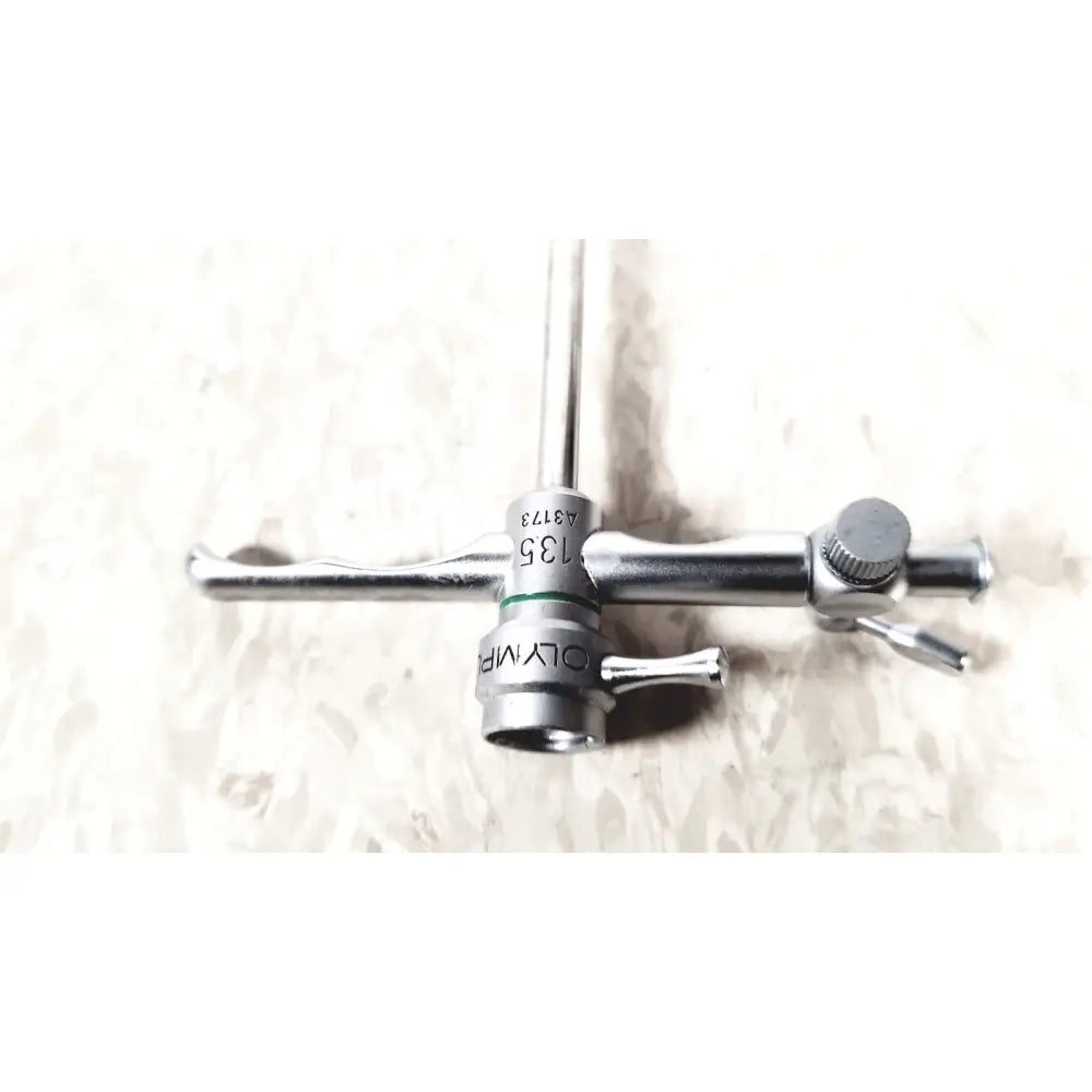Silver olympus a3173 sheath surgical instrument with textured handle and engraved markings for precise use