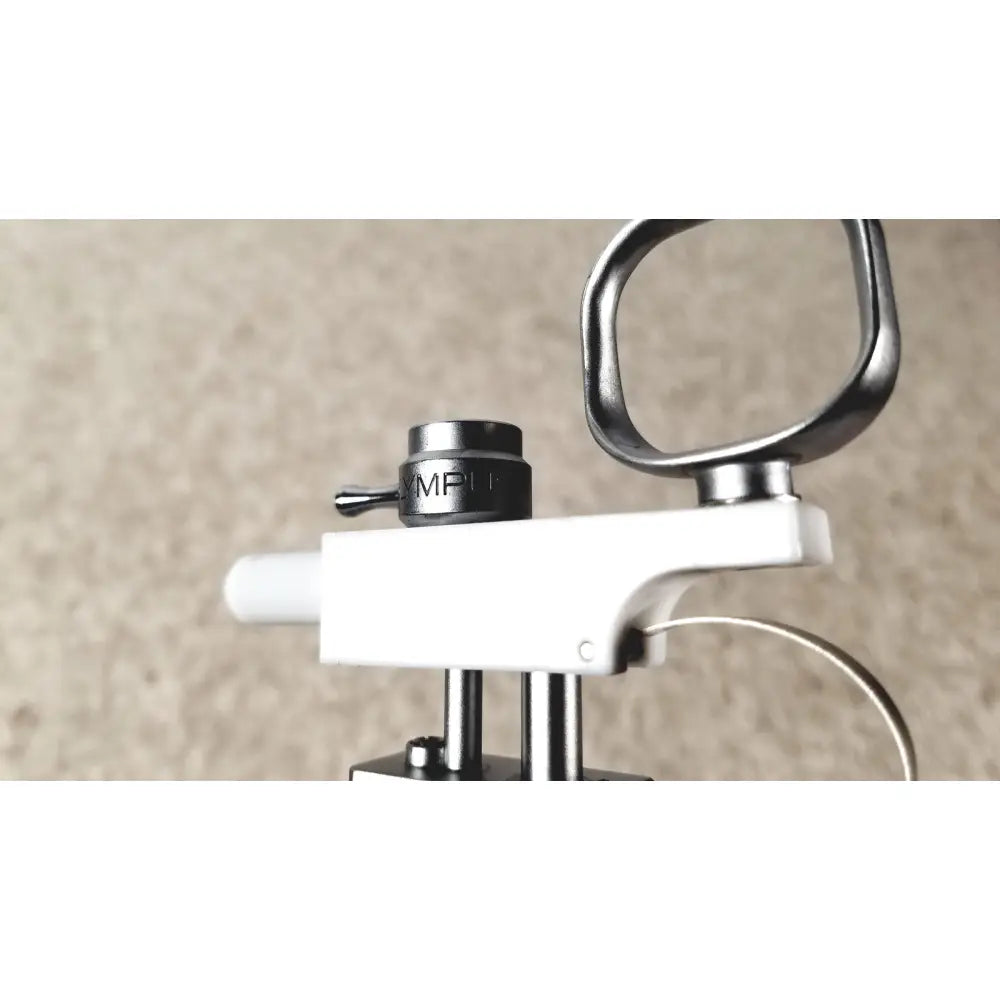 Black mpi-branded adjustment knob on white and metallic olympus a3176 laparoscopic pediatric iglesias device