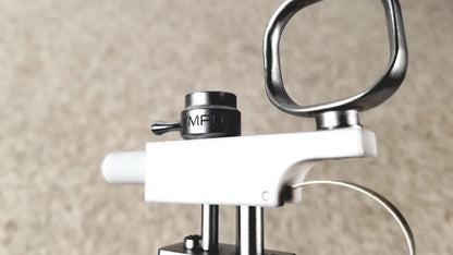 Black mpi-branded adjustment knob on white and metallic olympus a3176 laparoscopic pediatric iglesias device