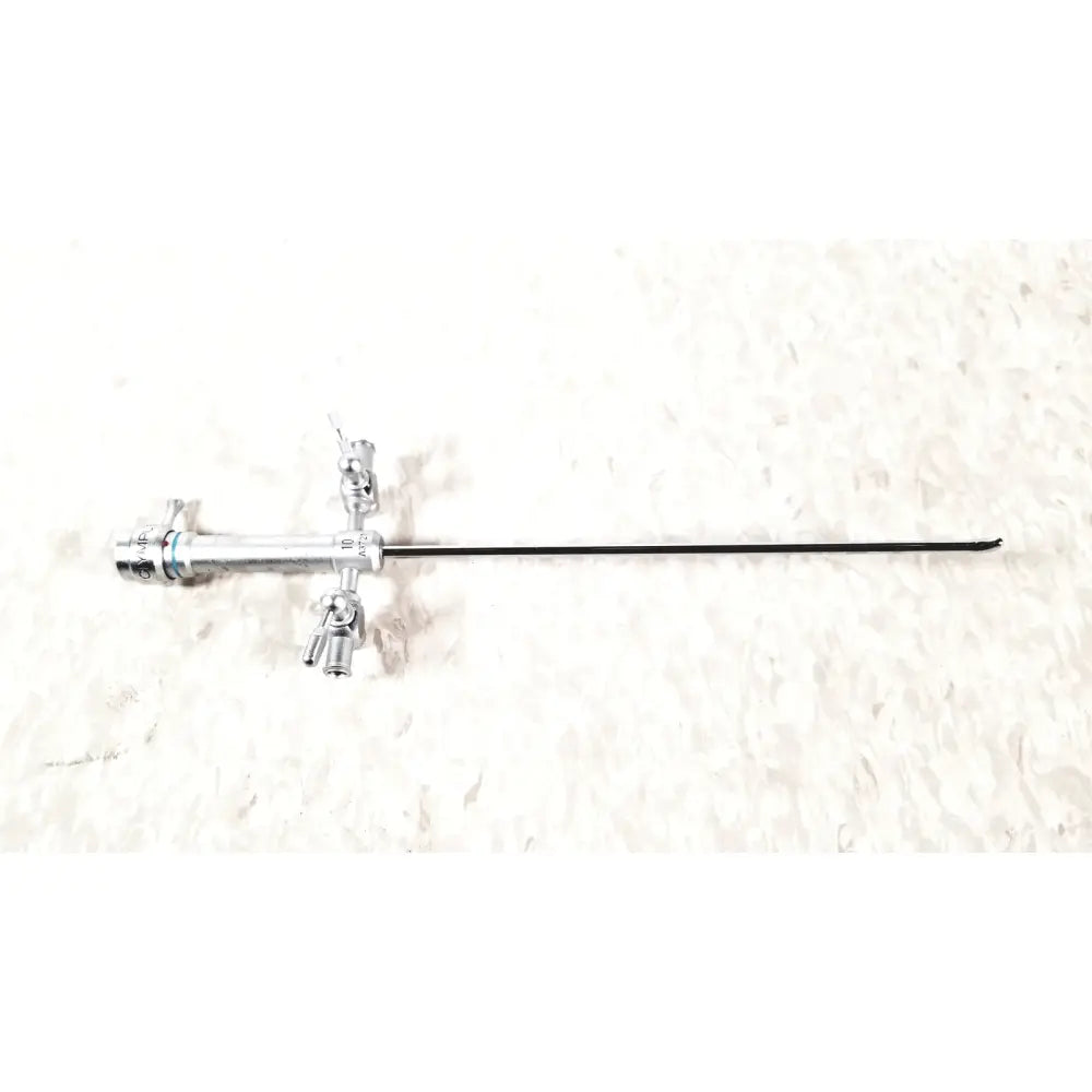 Silver surgical instrument with long black shaft and articulated knobs in olympus a3721 pediatric dual port sheath