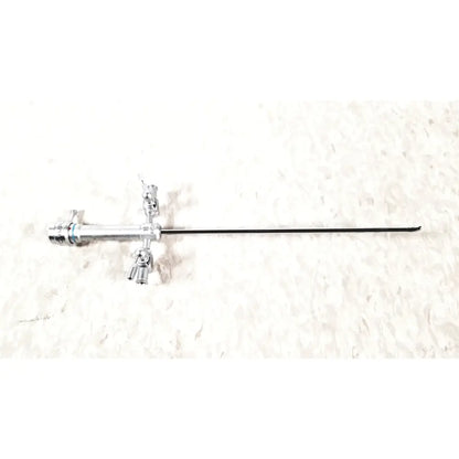 Silver surgical instrument with long black shaft and articulated knobs in olympus a3721 pediatric dual port sheath