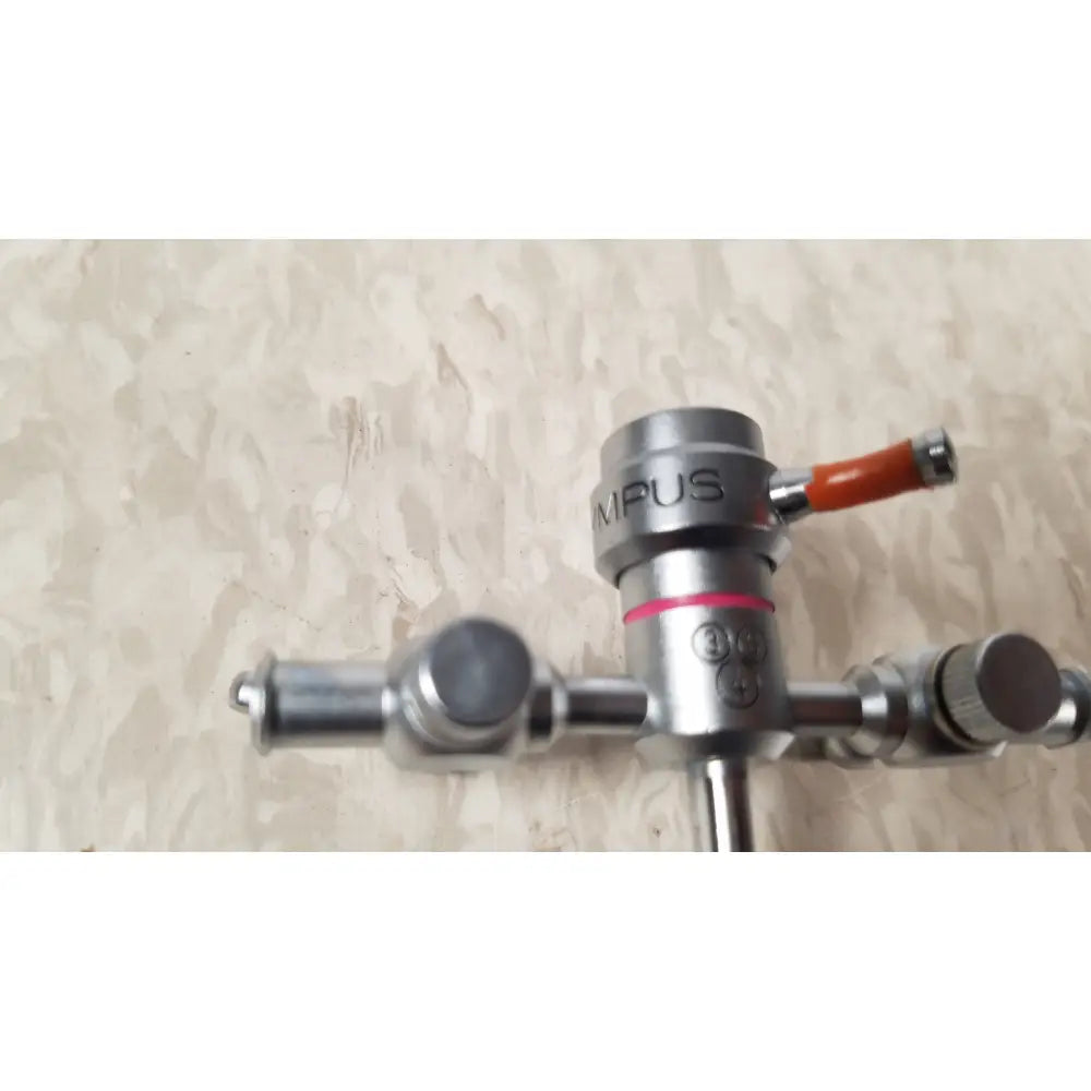 Silver metallic surgical gas valve with orange handle and red accent on olympus a3722 pediatric sheath 13 fr instrument