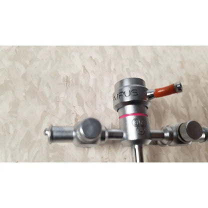 Silver metallic surgical gas valve with orange handle and red accent on olympus a3722 pediatric sheath 13 fr instrument