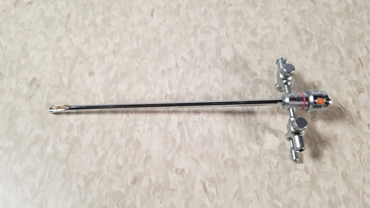 Silver-colored olympus a3722 pediatric sheath instrument with long slender shaft and complex control handle with knobs
