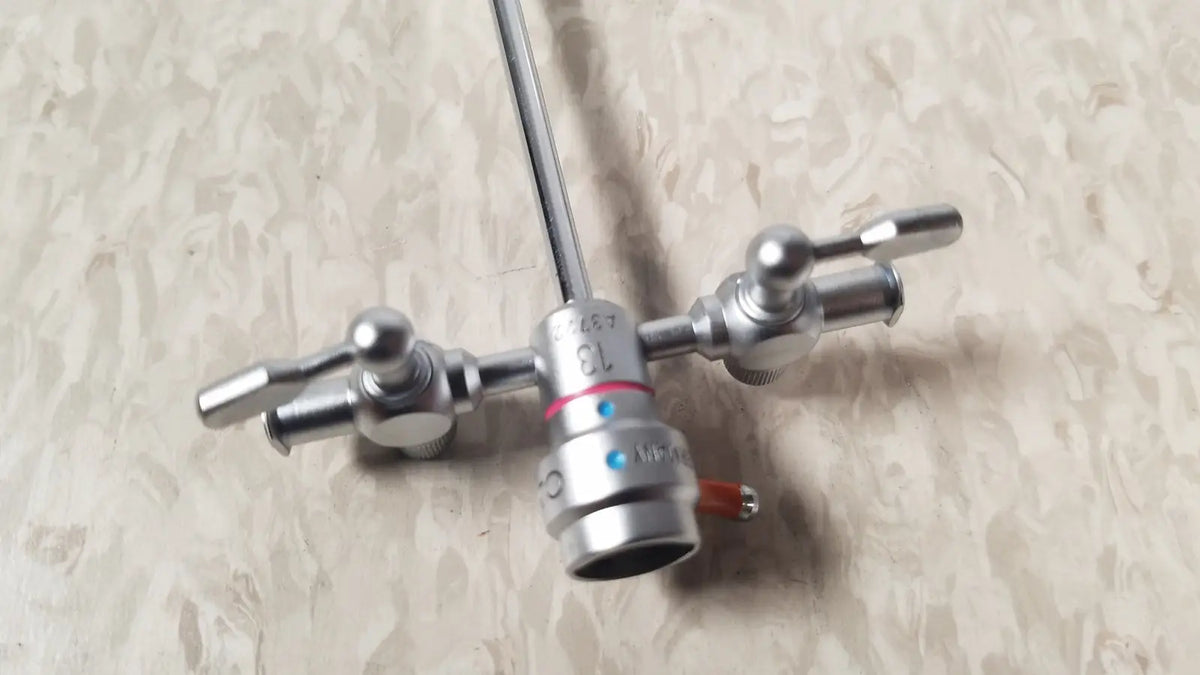 Silver surgical instrument with long shaft and three adjustable knobs in olympus a3722 pediatric sheath 13 fr instrument