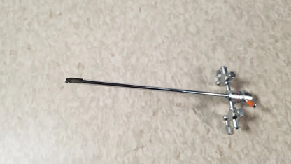 Silver-colored olympus a3722 pediatric sheath instrument with long slender shaft and articulated jointed end for medical use