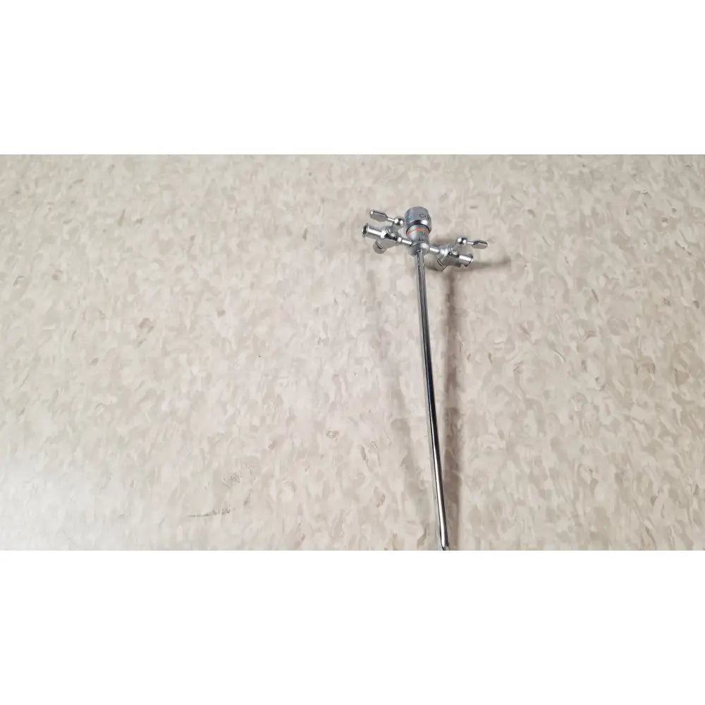 Silver-colored metal faucet with two handles and long spout shown alongside olympus a3723 pediatric sheath 14 fr instrument
