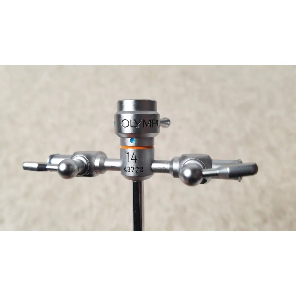 Silver olympus a3723 pediatric sheath surgical instrument with central shaft and two arms ending in spherical knobs