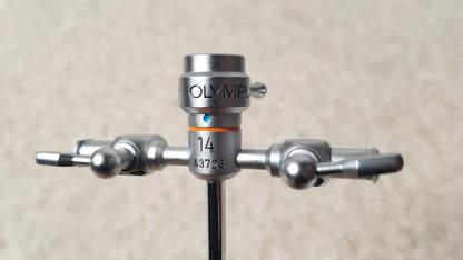 Silver olympus a3723 pediatric sheath surgical instrument with central shaft and two arms ending in spherical knobs