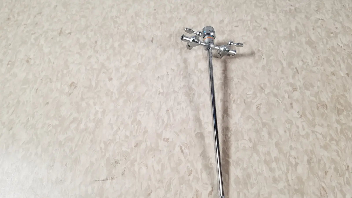 Silver-colored metal faucet with two handles and long spout shown alongside olympus a3723 pediatric sheath 14 fr instrument