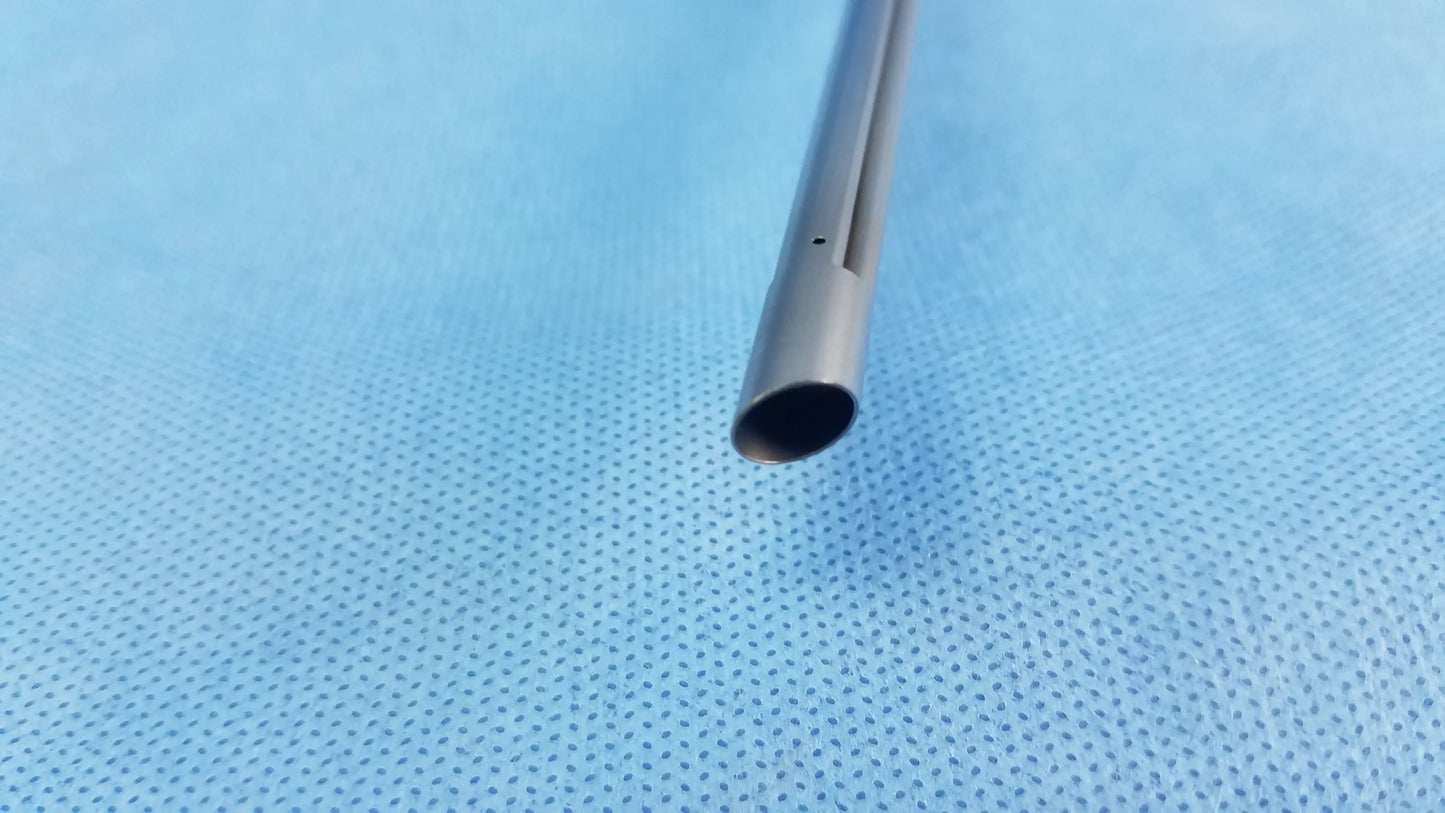 A sleek metallic working insert a42091a with a cylindrical body and tapered end in a sterilization tray