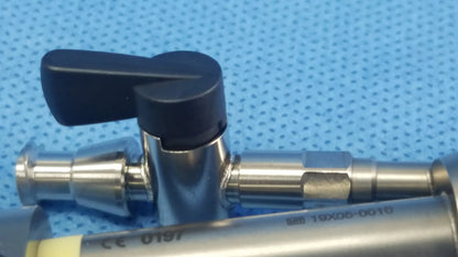 Stainless steel surgical valve with black plastic handle in olympus a42091a working insert with sterilization tray