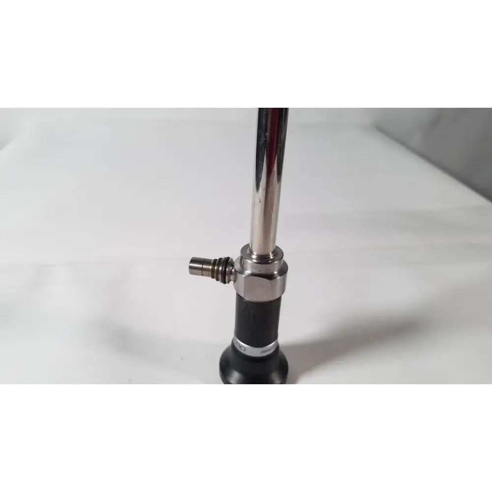 Shiny chrome olympus a5254 10mm laparoscope with black rubber grip and metallic joints for medical use