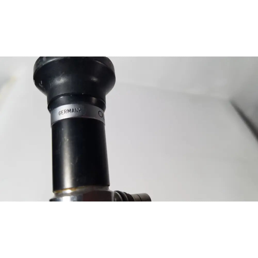 Black rubberized nozzle with a silver band inscribed germany on the olympus a5254 10mm 0 degree laparoscope
