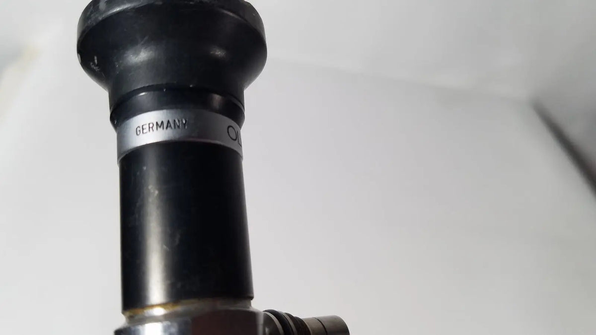 Black rubberized nozzle with a silver band inscribed germany on the olympus a5254 10mm 0 degree laparoscope