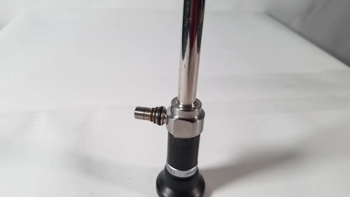 Shiny chrome olympus a5254 10mm laparoscope with black rubber grip and metallic joints for medical use