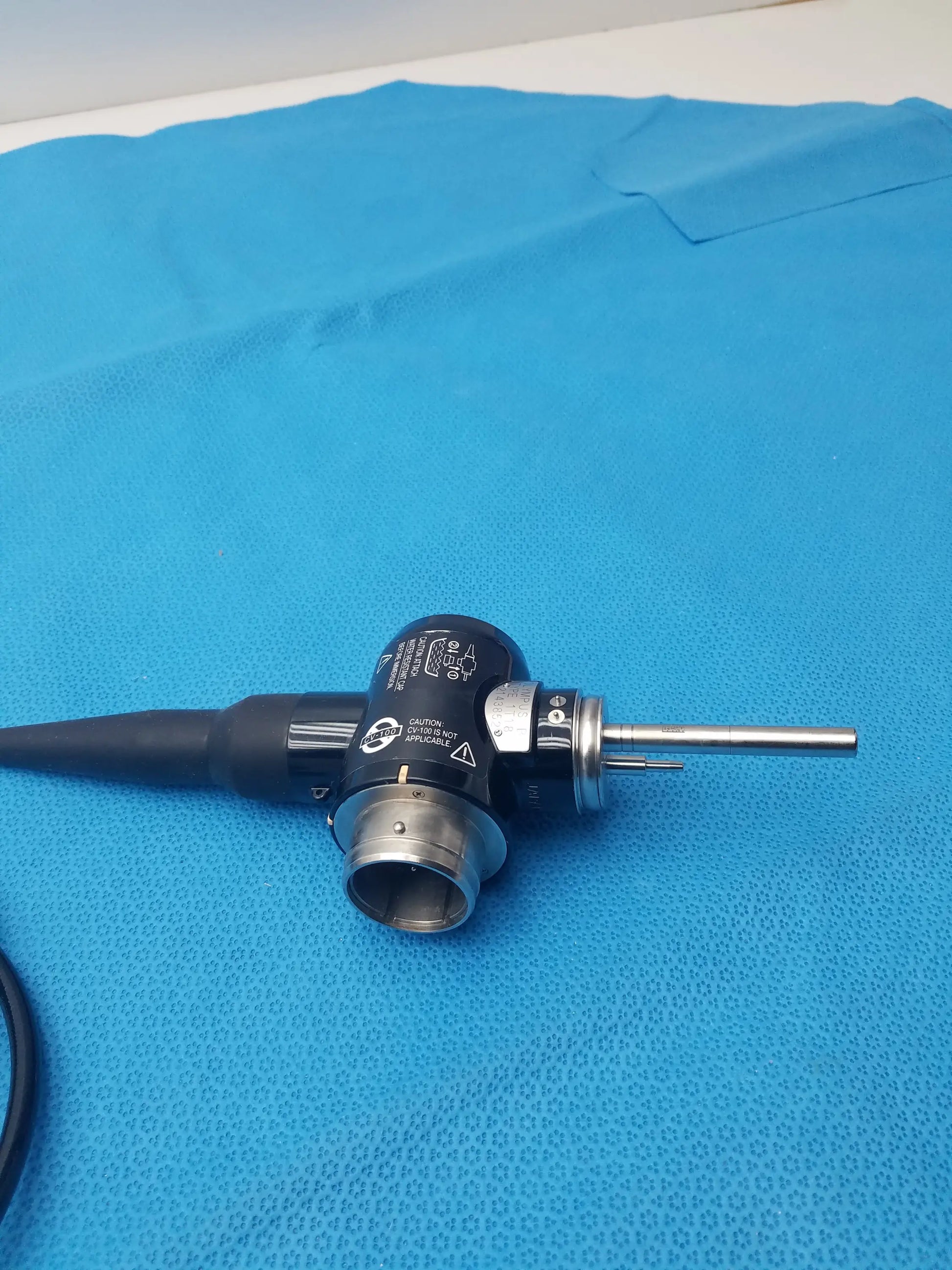 Black and silver Olympus Evis Exera type 1t180 video gastroscope with metallic tip and labeled components for medical use
