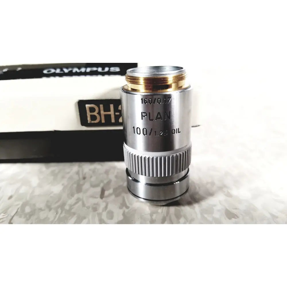 Silver metallic microscope objective lens with gold threaded top and markings on olympus bh-2 binocular microscope