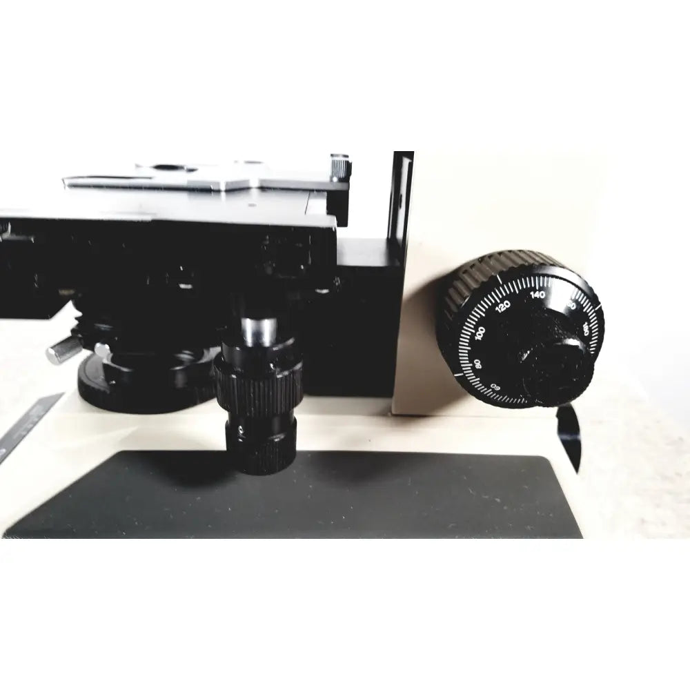 Black olympus bh-2 binocular microscope with textured focus knob and metallic objective lens for precise imaging