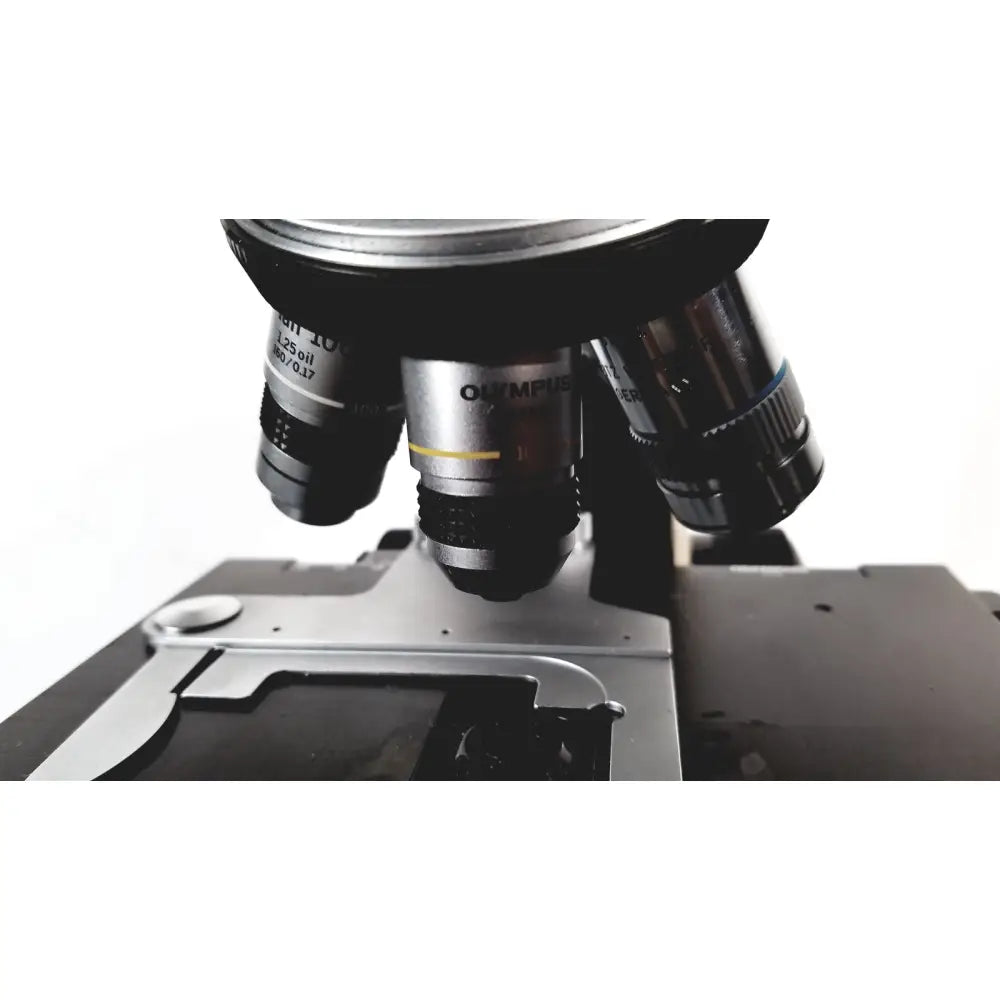 Black and silver olympus bh-2 binocular microscope with multiple objective lenses for advanced scientific use
