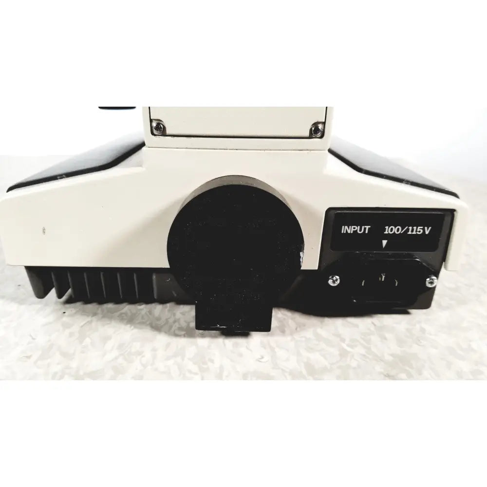White and black olympus bh-2 binocular microscope showing circular lens port and input 100/115v power panel