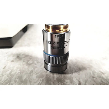 A sleek metallic microscope objective lens with gold ring and leitz wetzlar germany engraving for olympus bh-2 binocular microscope
