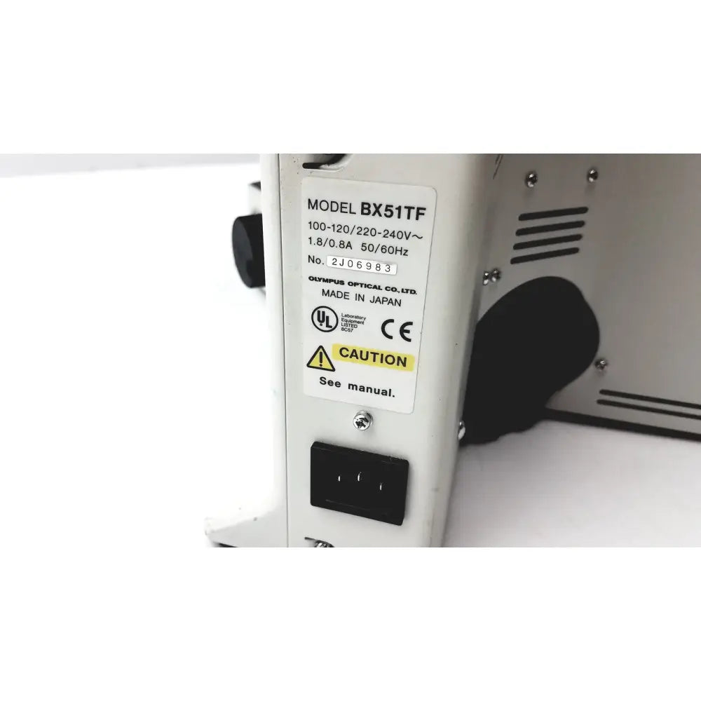 Back view of white olympus bx51tf microscope showing black power input port and ventilation slots with some body damage