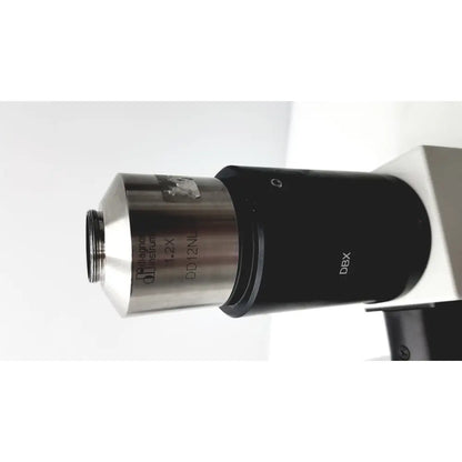 Black and silver microscope objective lens with engraved markings and metallic finish for olympus bx51tf microscope with some body damage