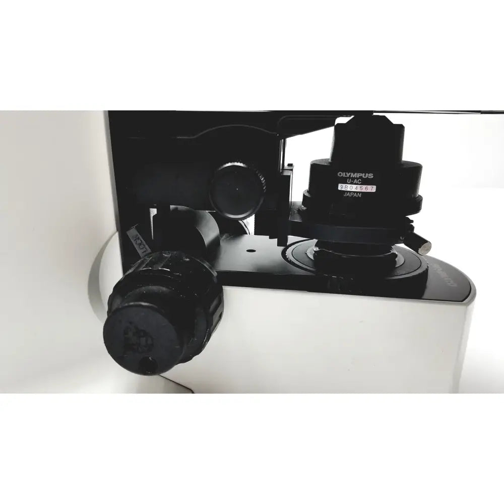 Black olympus bx51tf microscope objective lens with matte finish and engraved branding showing some body damage