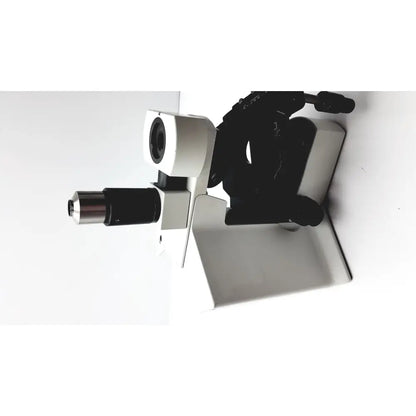A sleek white and black olympus bx51tf microscope with metallic accents and some damage on the body, fully functional
