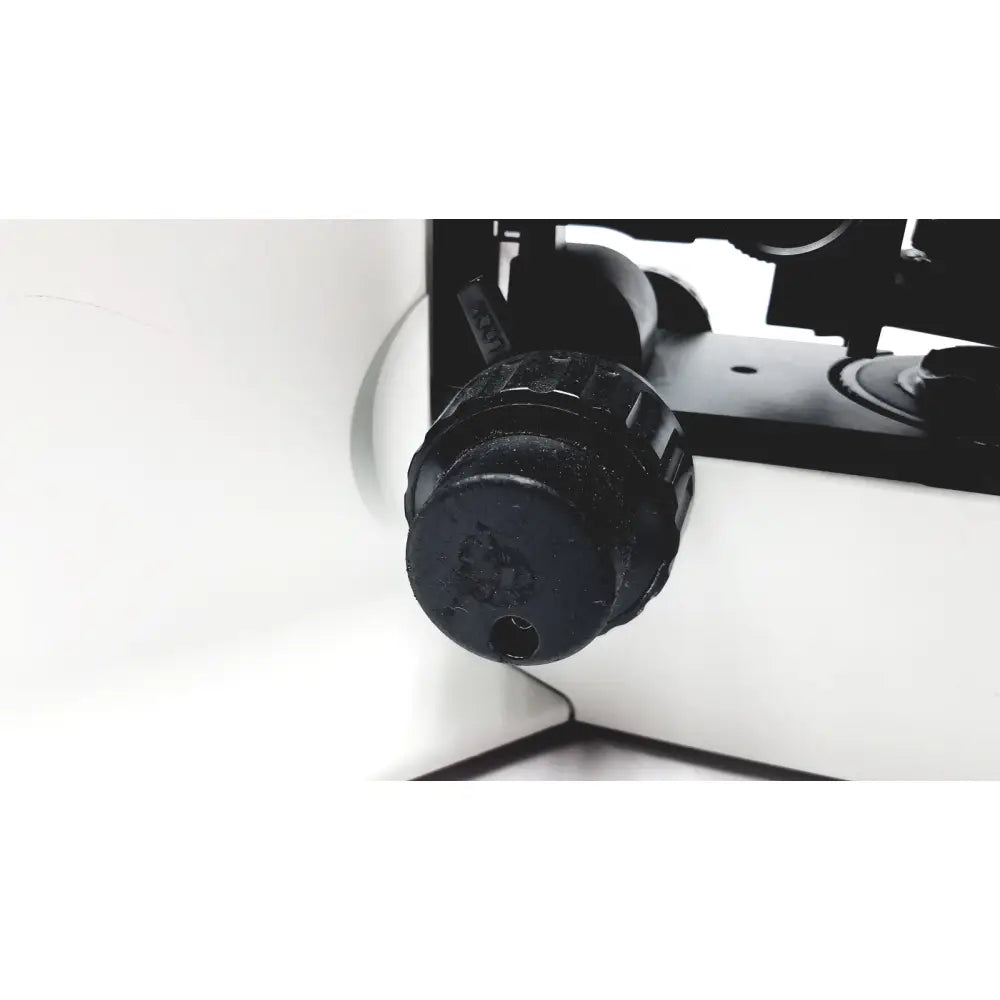 Black textured knob with central hole and engraved markings on olympus bx51tf microscope with body damage
