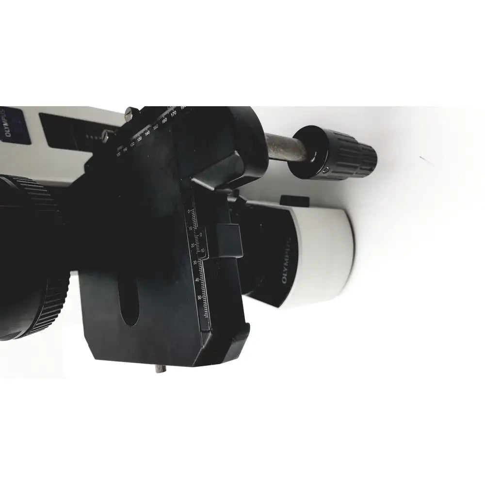 Black and white olympus bx51tf microscope with adjustable focus knobs and measurement scales showing minor body damage